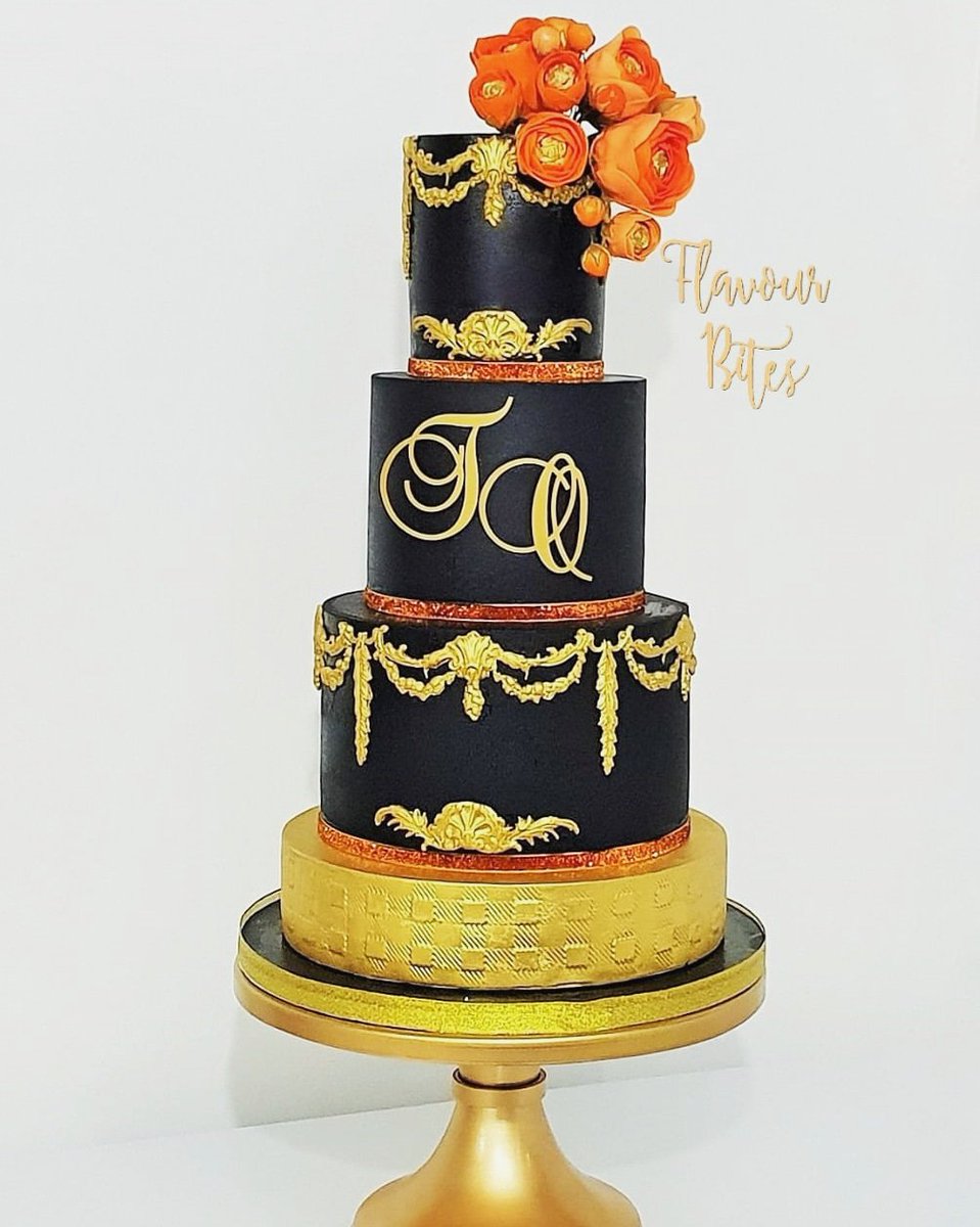 FlavourBites's tweet photo. Bold and Beautiful. Black &amp; gold wedding cake, featuring baroque border scrolls and acrylic monogram. Finished with rannuculus gumpaste flowers in shades of orange and coral.  #pantonecolouroftheyear2019 #WeddingPlanner
#weddingcake
#luxuryweddingcakes #2019bride #2020brides https://t.co/9Xst4Kkc0N