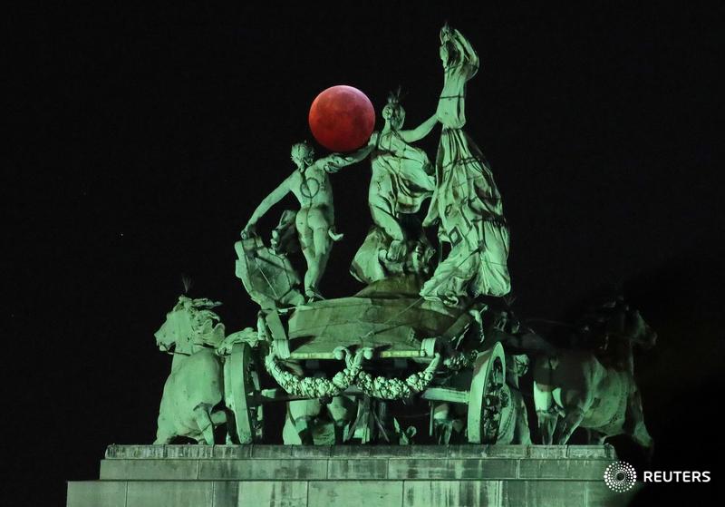 The Super Blood Wolf Moon is seen on top of the Cinquantenaire arch during the total lunar eclipse in Brussels, Belgium, and more photos of the day: https://reut.rs/2sFhW7O | 📷 Yves Herman
