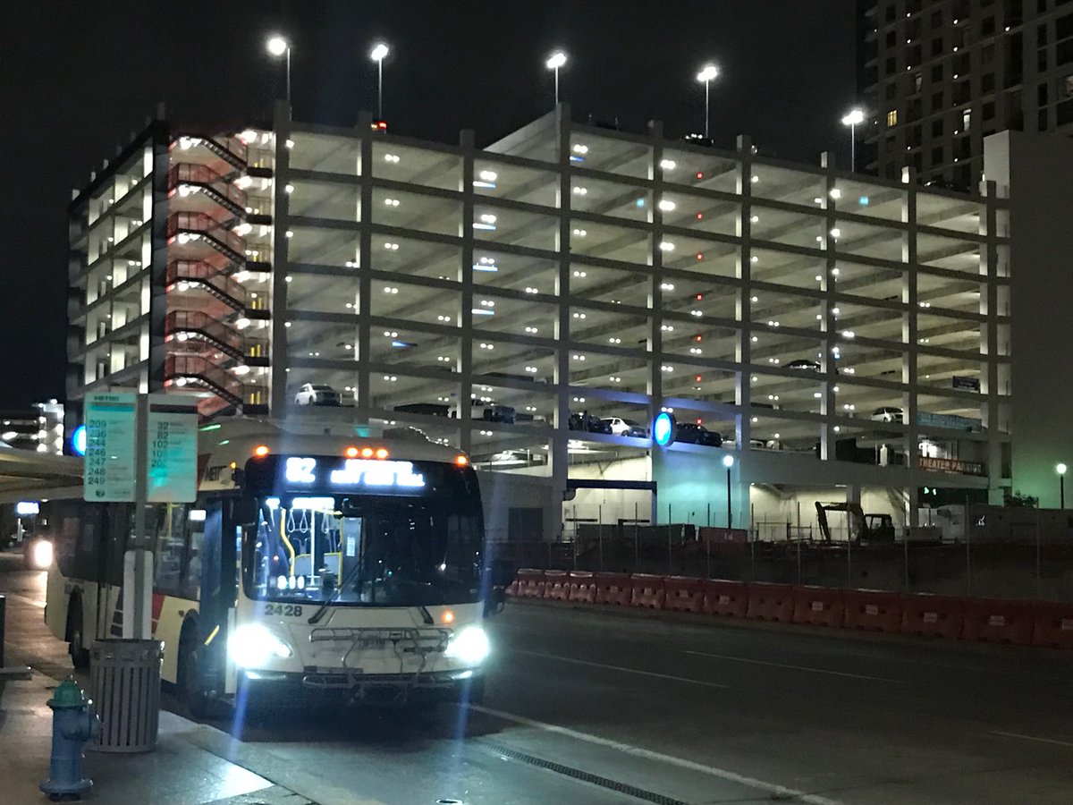 One of transit’s big advantages is the efficient use of urban space. The parking garage in the background stores 890 cars. The bus route in the foreground carries 6,200 round trips on an average weekday.