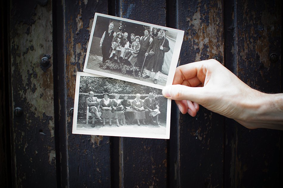 a woman holding up two vintage photos