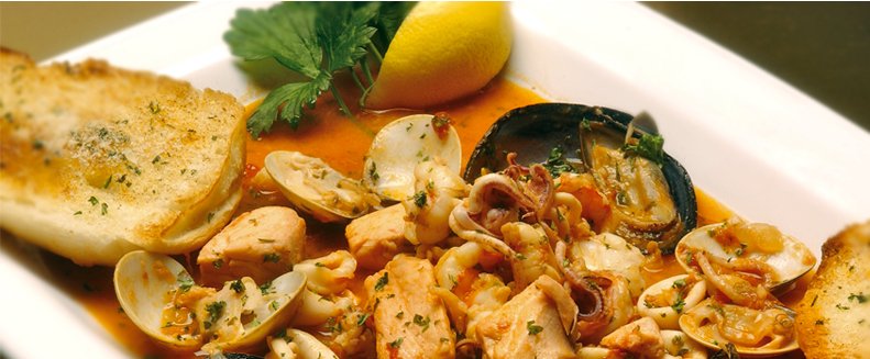 Zuppe di Pesce - Fresh Fish soup with chunks of Lobster, Shrimp, Mussels, Clams and Salmon with a touch of Marinara. Served with garlic bread. The best at Dominic's on the Hill! #zuppedipesche #italianfood #freshfish #greatitalianfood #romanticsetting