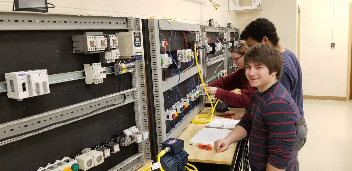 CCA students working diligently on a Programmable Logic Controller!