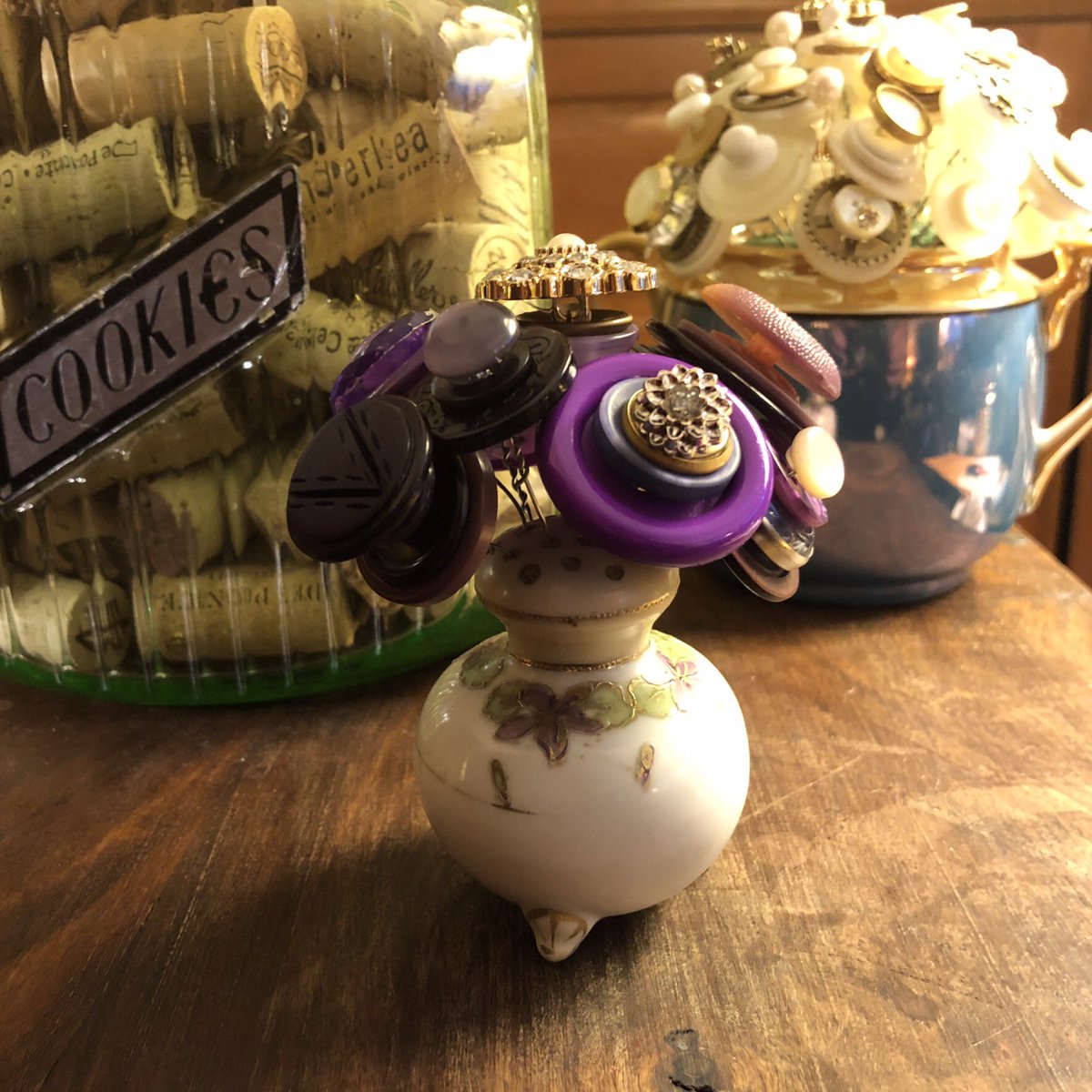 I admit it, I’m addicted to making Button Floral Arrangements! Salt Shakers, Mini Teapots, Vintage Vases ... all are fun to use. Check out my Etsy shop ... All Buttoned Up By Tina.