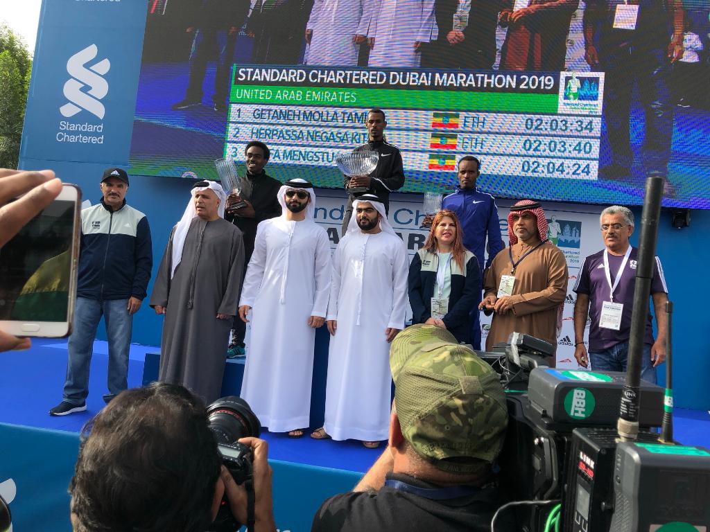 StanChartUAE's tweet photo. H.H Sheikh Mansoor bin Mohammed Al Maktoum and our CEO Rola Abu Manneh presenting the top three men and women from the full marathon and the 10k marathon with medals.
#ItsNotJustRunning #SCBDXBMarathon #SCBUAE
#SCBDubaiMarathon #MyDubai https://t.co/2jLMqf5k9z