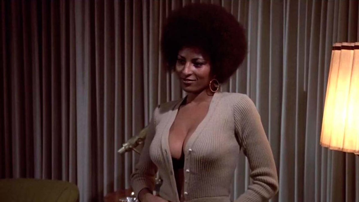 2. A young #sexy Pam Grier sporting an #afro, a low cut dress and getting h...