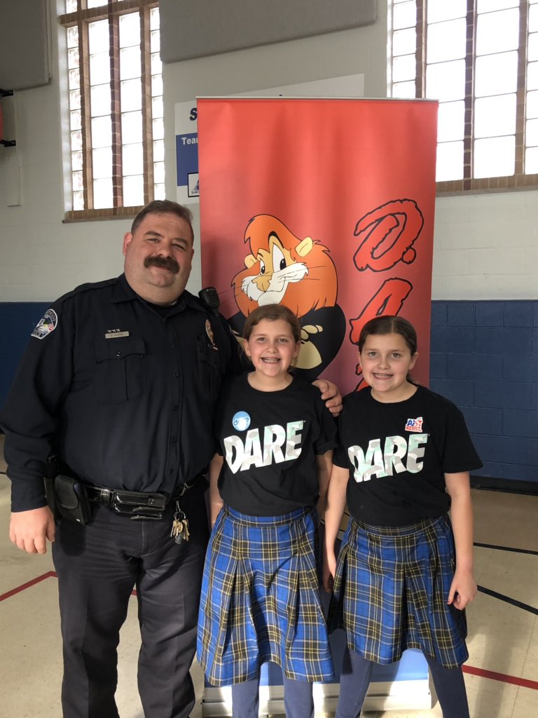 CarrieCMitchell's tweet photo. 5th grade DARE graduation with Officer Olson @HolyCrossStl #OLP! When I was a little girl, Officer Friendly was the police presence in our schools. It was cool that my dad was a policeman. Thank you @CrestwoodMO for offering this awesome program for our kiddos! #MitchellTwins https://t.co/CtI2uEFLG4