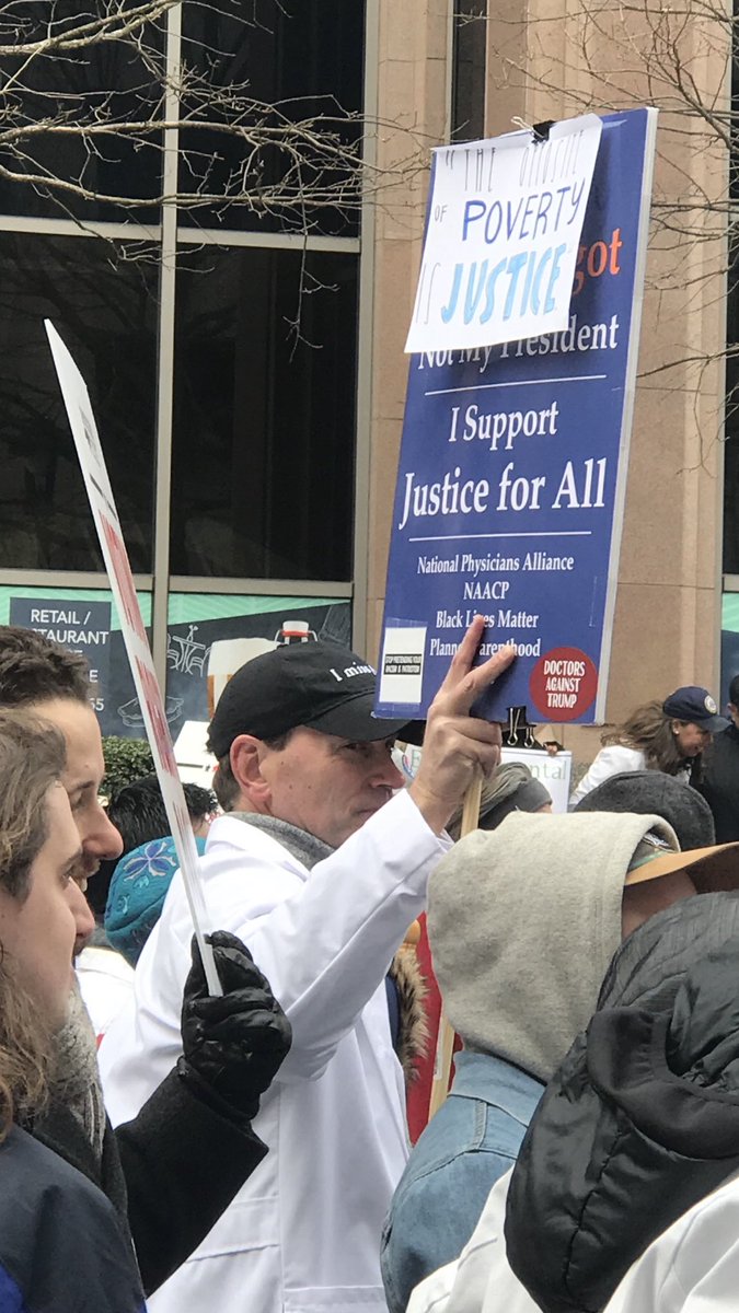 gracievdaniel's tweet photo. still my all-time favorite dude. marching with the best sign in his white coat with other doctors today. please zoom in on pic 3 to see “stop defending your racism as patriotism” 👏#doctorsagainstTrump #healthoverprofit https://t.co/2Mw1cEHOIl