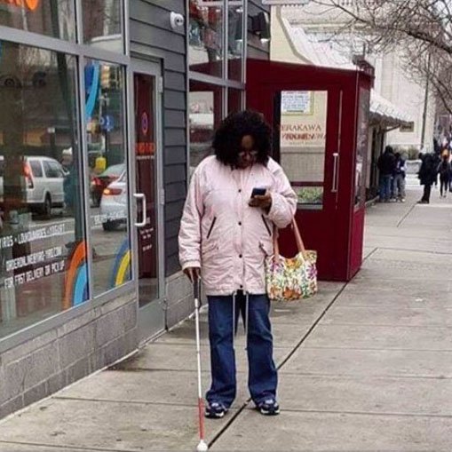 RNIB's tweet image. This photo of a woman with a cane using her phone has been shared 1000s of times, with people saying she is faking being blind.

Sight loss is a spectrum and blind people use phones, read Kindles and watch TV in many ways.

We urge everyone to see the person, not the sight loss.