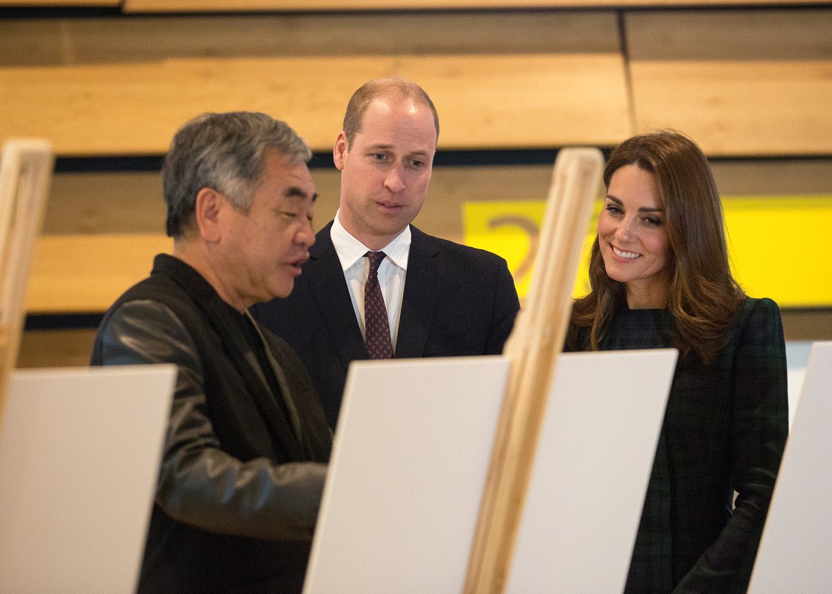 The Duke and Duchess of Cambridge standing behind easels talking to Kengu Kuma, architect of V&A Dundee.
