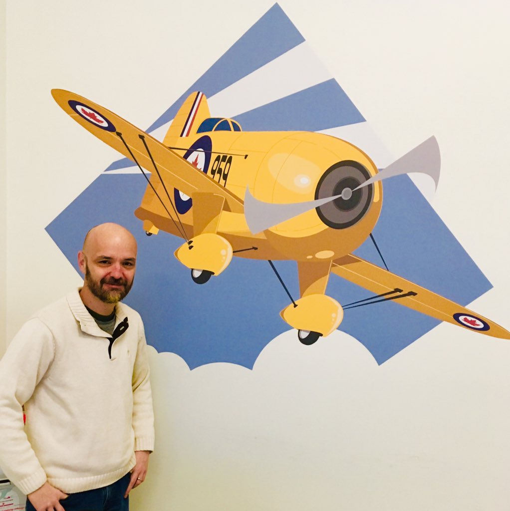 tphcanada's tweet photo. Jim our design specialist in Ottawa proudly shows off the wall mural he made for our Constitution Square location. Come check us out if you are in town for the #MPIOttawa or #PTiO shows. We are the proud print sponsors for both events! #Ottawa #MakingYouLookGood #GeeBee #RCAF https://t.co/Noji9eQ4x1