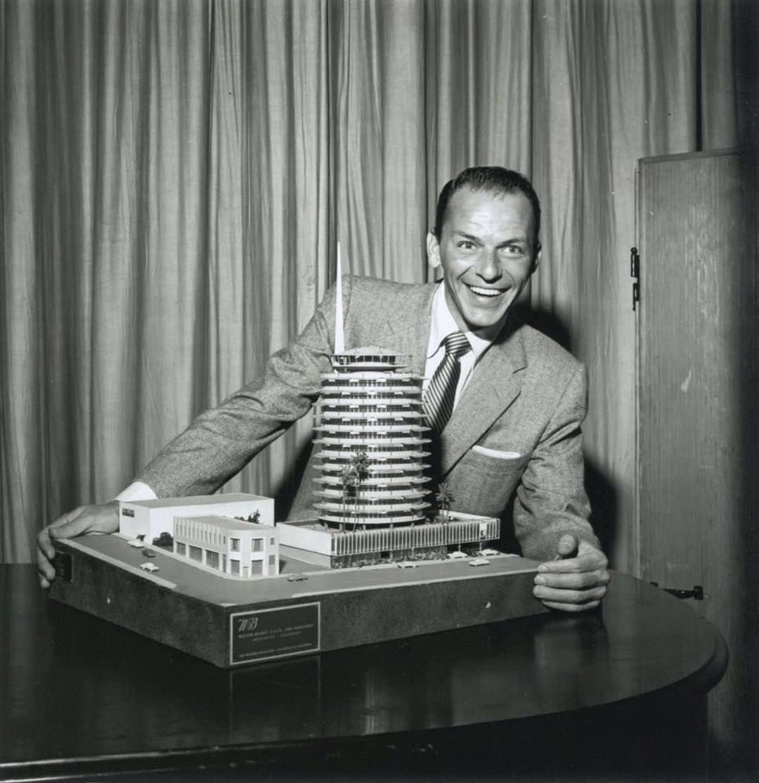 One of the all-time greats, @FrankSinatra, with a model of the soon-to-be-constructed @CapitolRecords Tower in Hollywood, CA circa 1955. #TBT 
Source: @FrankSinatra 
#CapitolHistory #CapitolVaults