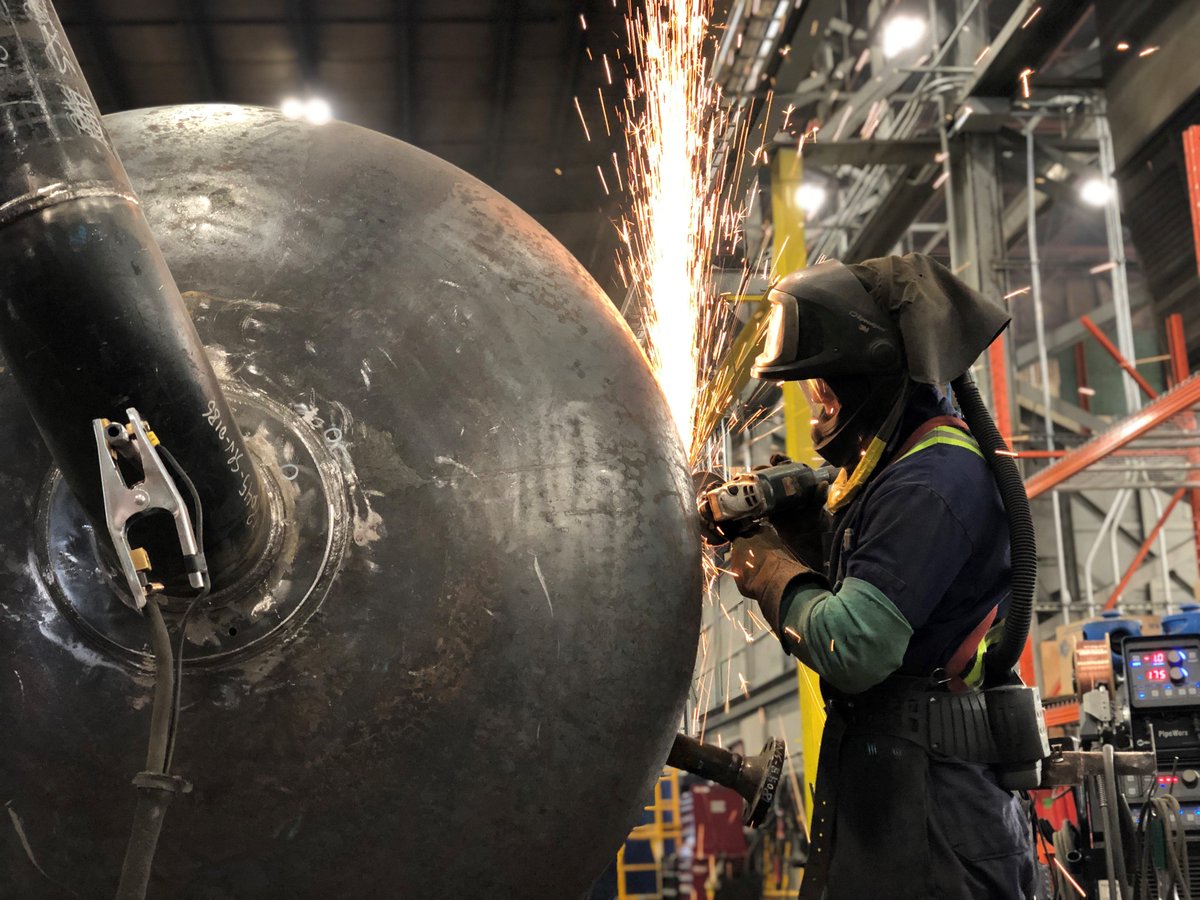 Pressure vessels like this tower are engineered, designed, and built by our #EverydayMavericks, who are busy creating sparks once again in our shop today while working on the base welds for a deethanizer tower that will stand roughly 70' tall once complete! #Welding #YYCEnergy