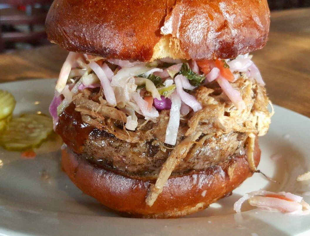 Introducing Al’s February creation, the Carolina BBQ Burger.   As you’ve come to expect, it all starts with our signature half pound ground chuck and short rib blend patty, grilled to order then topped with slow-roasted pulled pork, our Carolina coleslaw and house-made BBQ sauce.