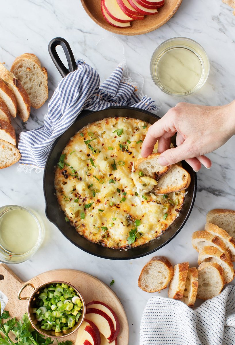 I never miss a chance to bring back this Baked Cheesy Cauliflower Party Dip. If you're watching the Superbowl this weekend, it's a must-try. It's creamy, tangy &amp; even healthy, with a whole head of cauliflower hidden inside! loveandlemons.com/baked-cheesy-c…