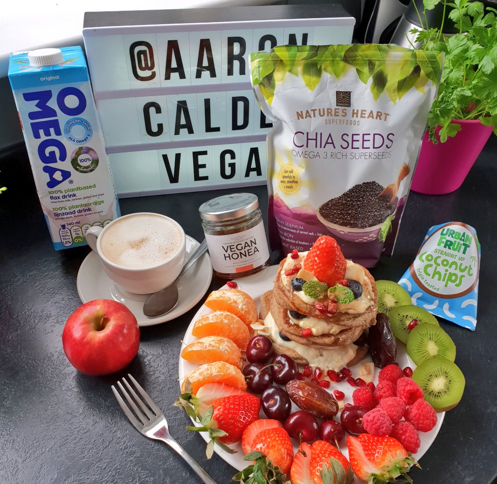 Oat &amp; Brown Rice Pancakes. With cinnamon, ginger, chia seeds @naturesheartuk, omega flax milk &amp; Alpro no added sugar mango yogurt. Sprinkled with coconut 🥥 chips. 
.
Loads of fresh fruits &amp; organic dates. Filter coffee with Oatly Whole milk. #vegan #plantbased