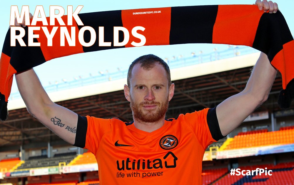 mark reynolds holds the scarf above his head.