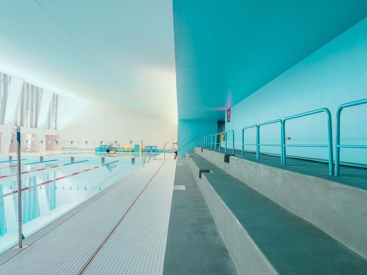 Adobe's tweet photo. Just keep swimming 🏊‍♀️. Photographer @LudwigFavre captures the beauty of indoor pool architecture: https://t.co/TImNaBKpOQ https://t.co/oLTmQqGEeS
