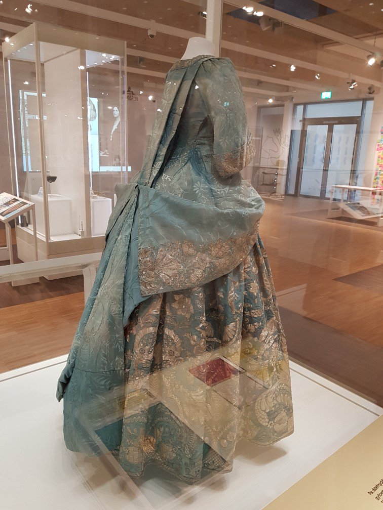 GrowlyCub's tweet photo. Here's the truly amazing silver thread embroidered court mantua (fr. Trededgar). Silk made in Spitalsfield ca. 1725. The silver thread is barely tarnished! I've never seen any silver embroidery in this fabulous shape. It absolutely sparkles! 1/2 #TravellingGrowly at St. Fagan's https://t.co/oUMsxgZ3fe