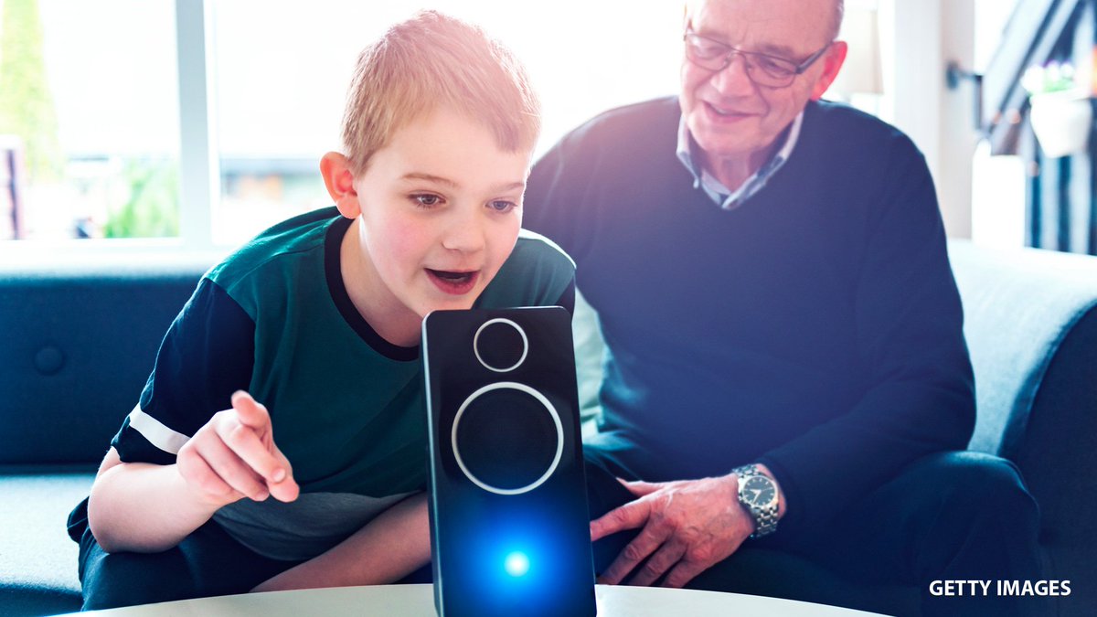 Boy and old man with a smart speaker