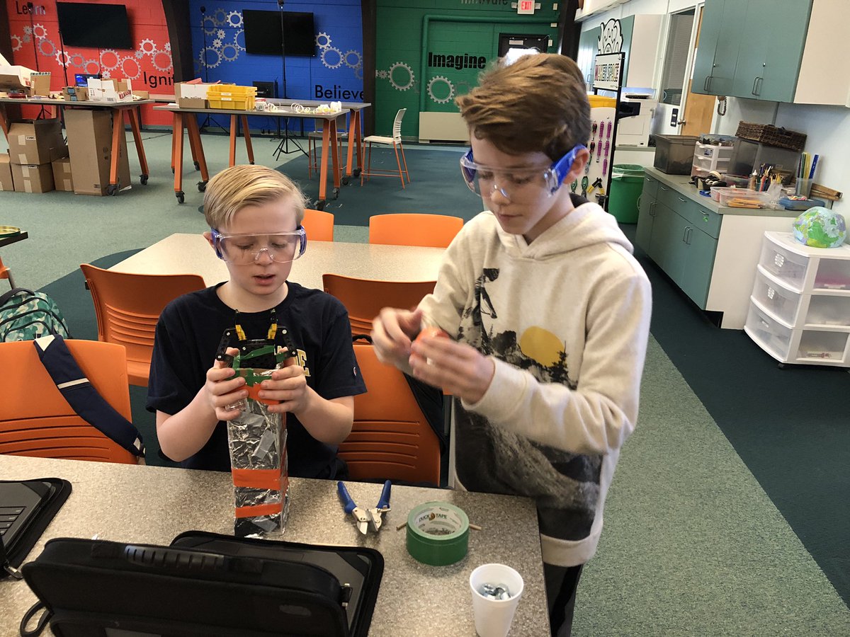 Fifth graders working on the exterior of their robotic arm design.