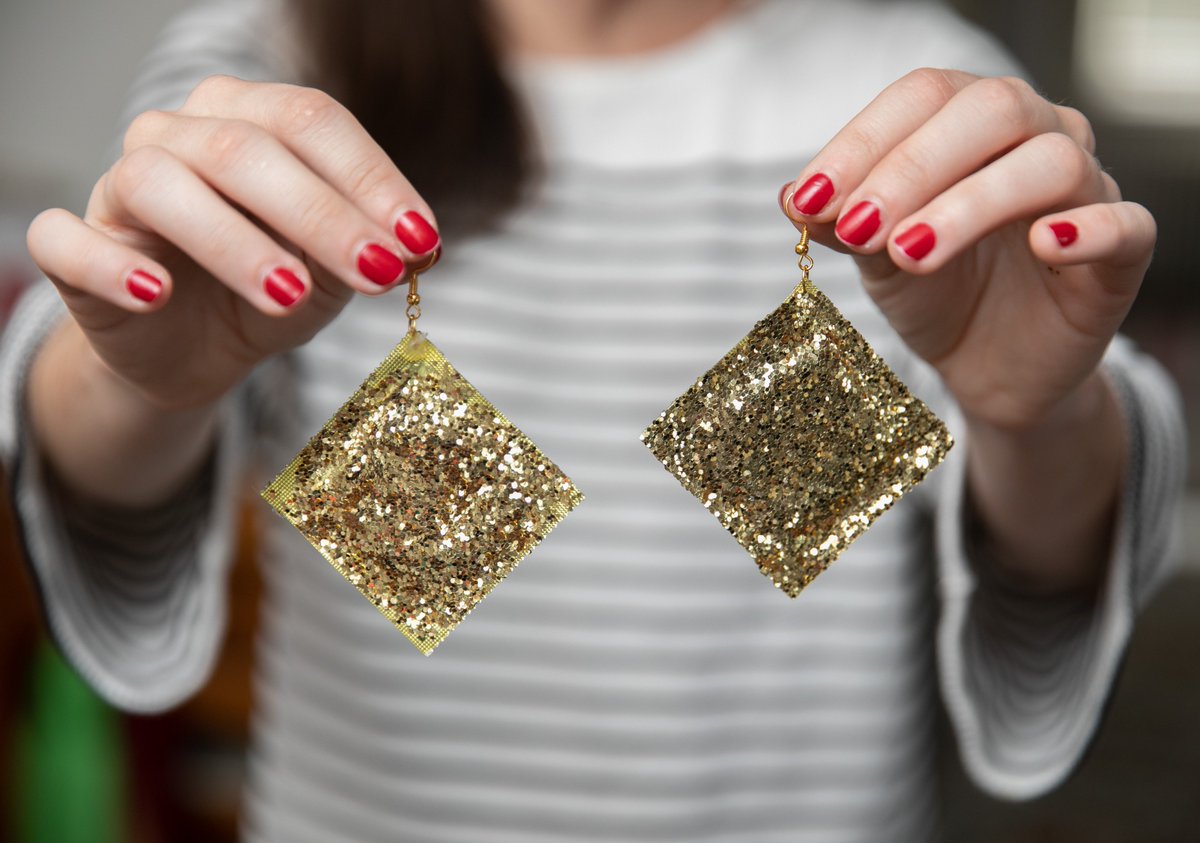 DIY glittery gold condom earrings