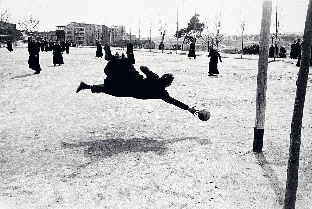 Seminarists playing football in Madrid, 1962, by Francesc Català-Roca(FWIW, I think the second goal post is to the left outside the frame!)