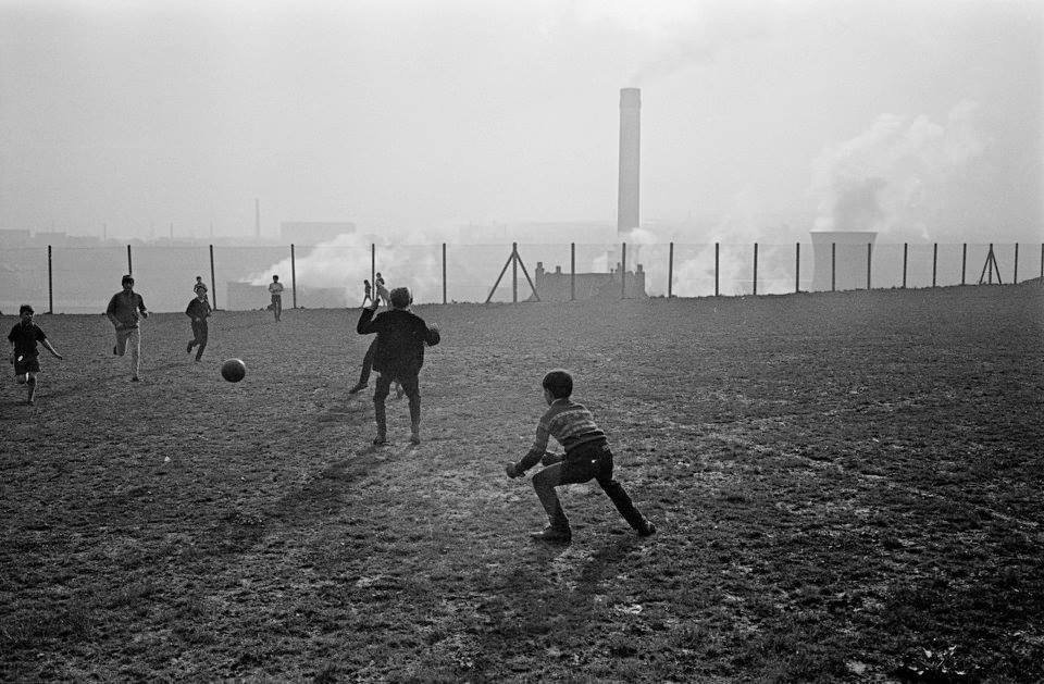 Nick Hedges, Boys playing football near the power station, Bradford, 1969