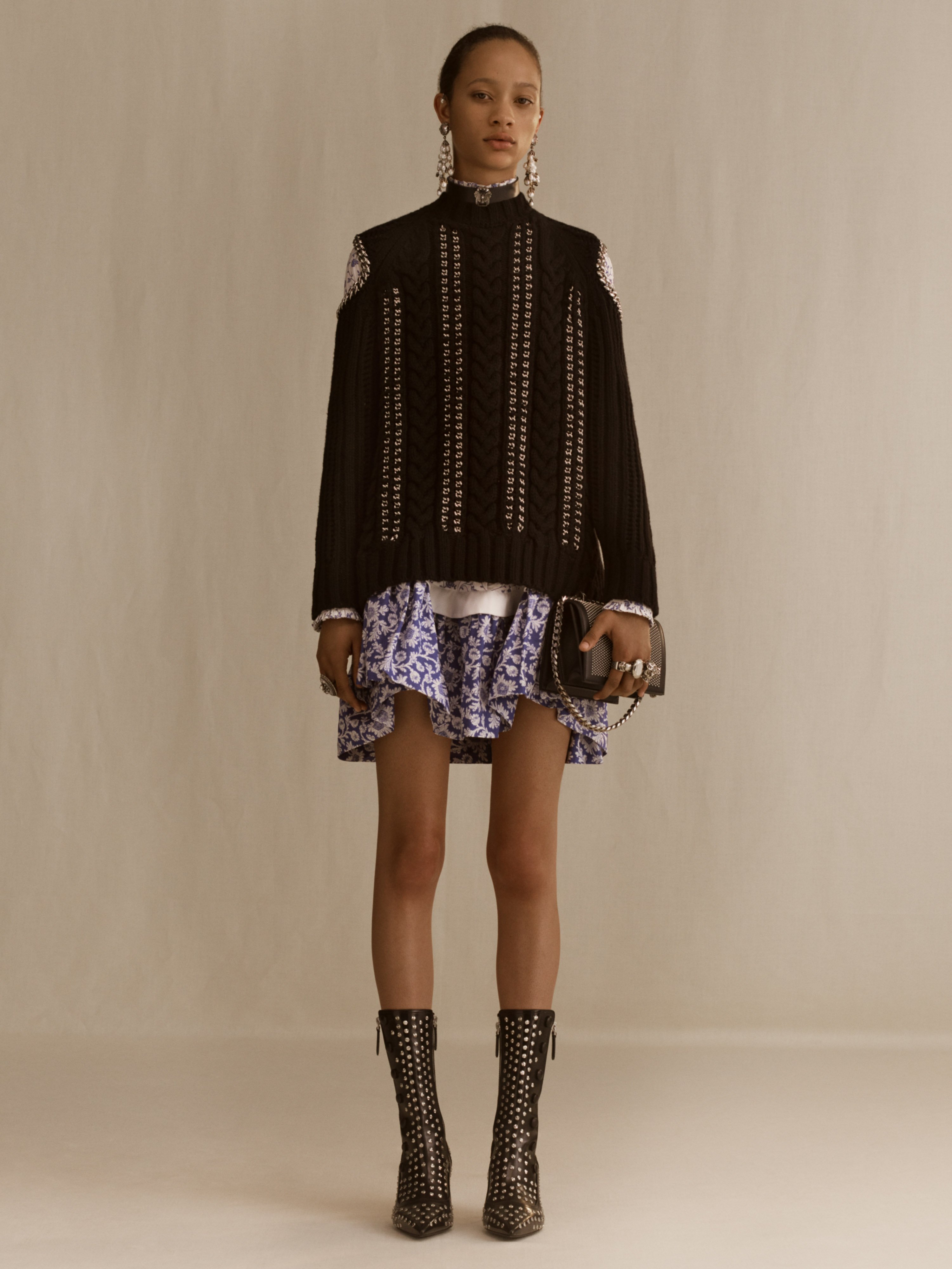 Alexander McQueen on X A cable knit cashmere jumper with woven chain detailing and an ivory and navy striped wool knit sweater with crystal rose embroidery. From the Alexander McQueen Spring Summer 20...