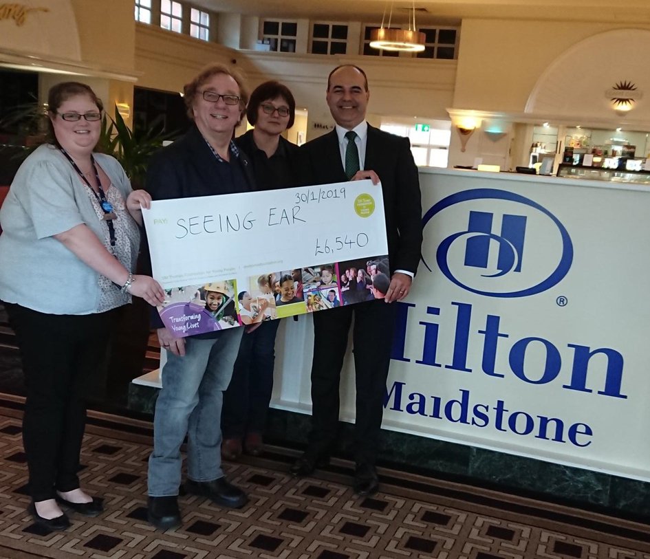 TheSeeingEar's tweet photo. We want to say a huge thank you to @HiltonMaidstone for presenting a grant from @DMTFYP to us last week, to help provide 1,000 books specially adapted for young people with visual impairments to enjoy in free of charge in our #NationalAccessibleLibrary! https://t.co/laca4avvdm