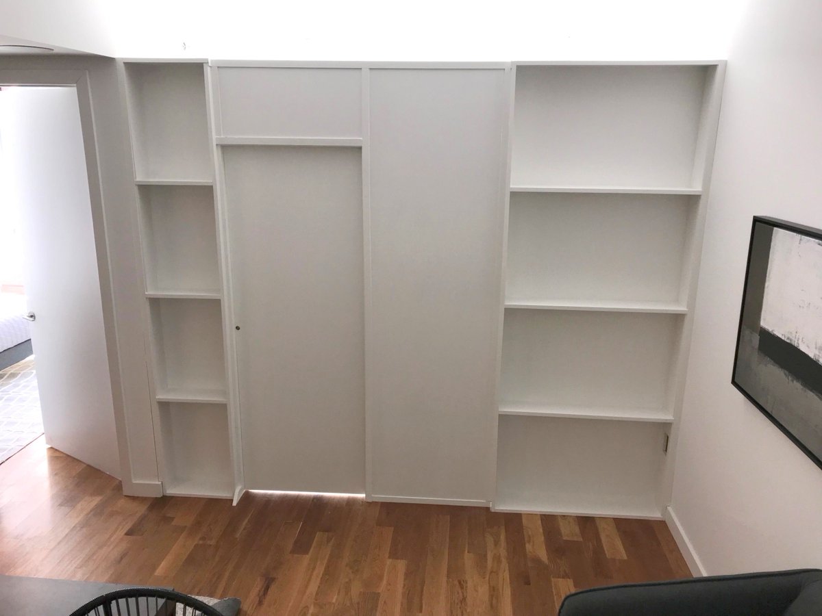 Wall2WallNY's tweet photo. Custom bookcase wall with pocket door. Call us for all your custom room partition and storage wall inquiries. (646) 837-7300 https://t.co/GXv9oHYoHw