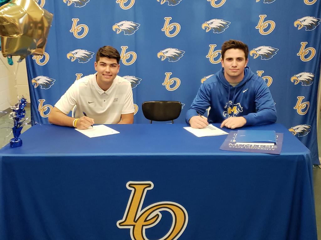 Live Oak's Sal Palermo (left) signs with Louisiana College and Blake Robinson with McNeese State during ceremony Wednesday at school. @LPNews1898 @LiveOakEagles @LiveOakFB @45ALockerRoom