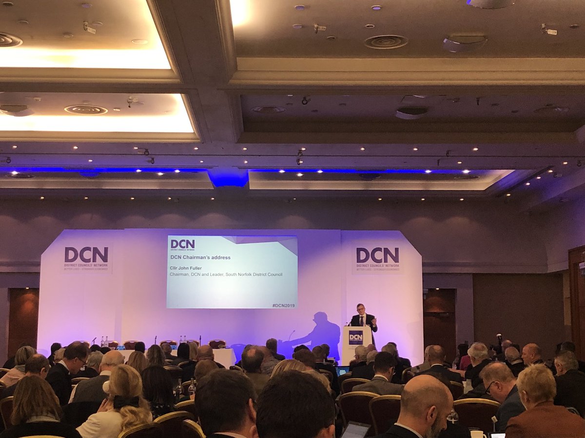DistrictAPPG's tweet photo. @districtcouncil national conference 2019 is kicking off in Kenilworth with an intro from  DCN chair, Cllr John Fuller from @SNorfolkCouncil to a packed room of Leaders, Chief execs and officers https://t.co/77eWLbfZwS