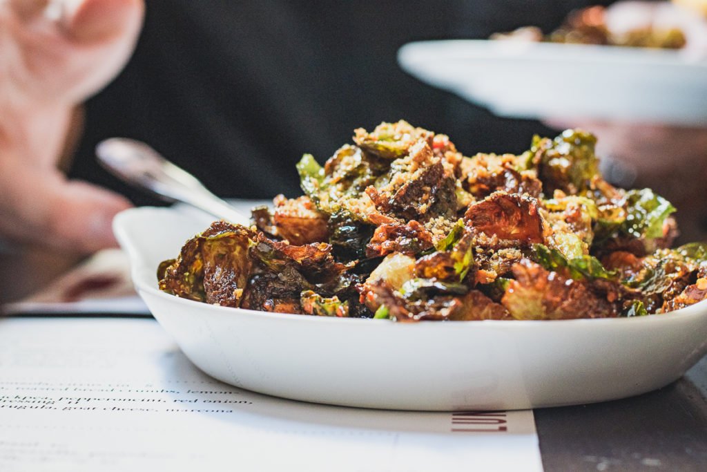 A small plate thats big on flavor. Our brussels sprouts with house hot sauce, sherry vin., &amp; pecan brittle crumbs.