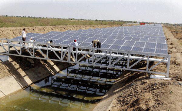This is an intelligent application of solar panels in India. No new land taken out of use and it reduces evaporation of the water in the aqueduct.