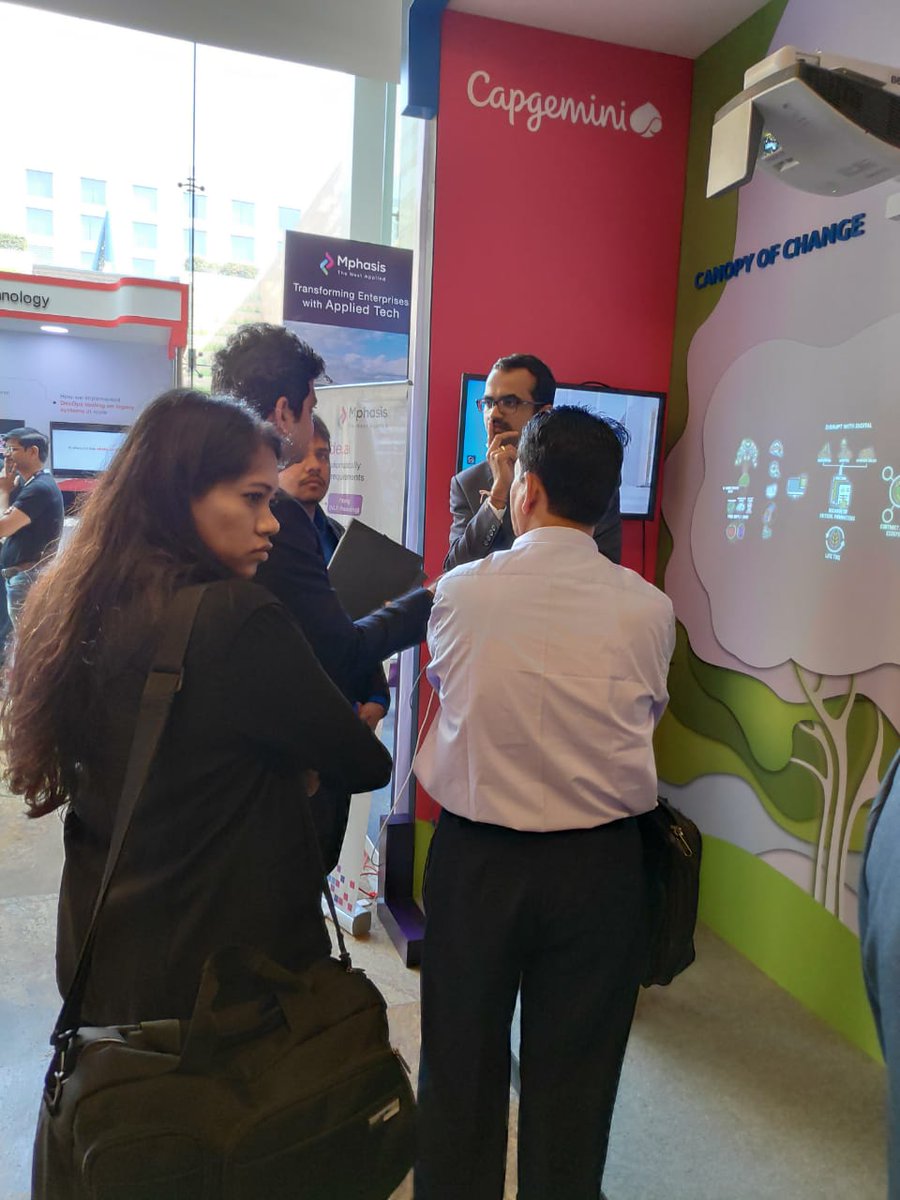 CapgeminiAIE's tweet image. #AIEMumbai expert @hmangirish during his session at Capgemini's Experience Zone. The screen behind him is the #CanopyOfChange - a creatively built #TreeOfKnowledge with our solutions as fruits that pushes stories to visitors. #CapgeminiAtNTLF