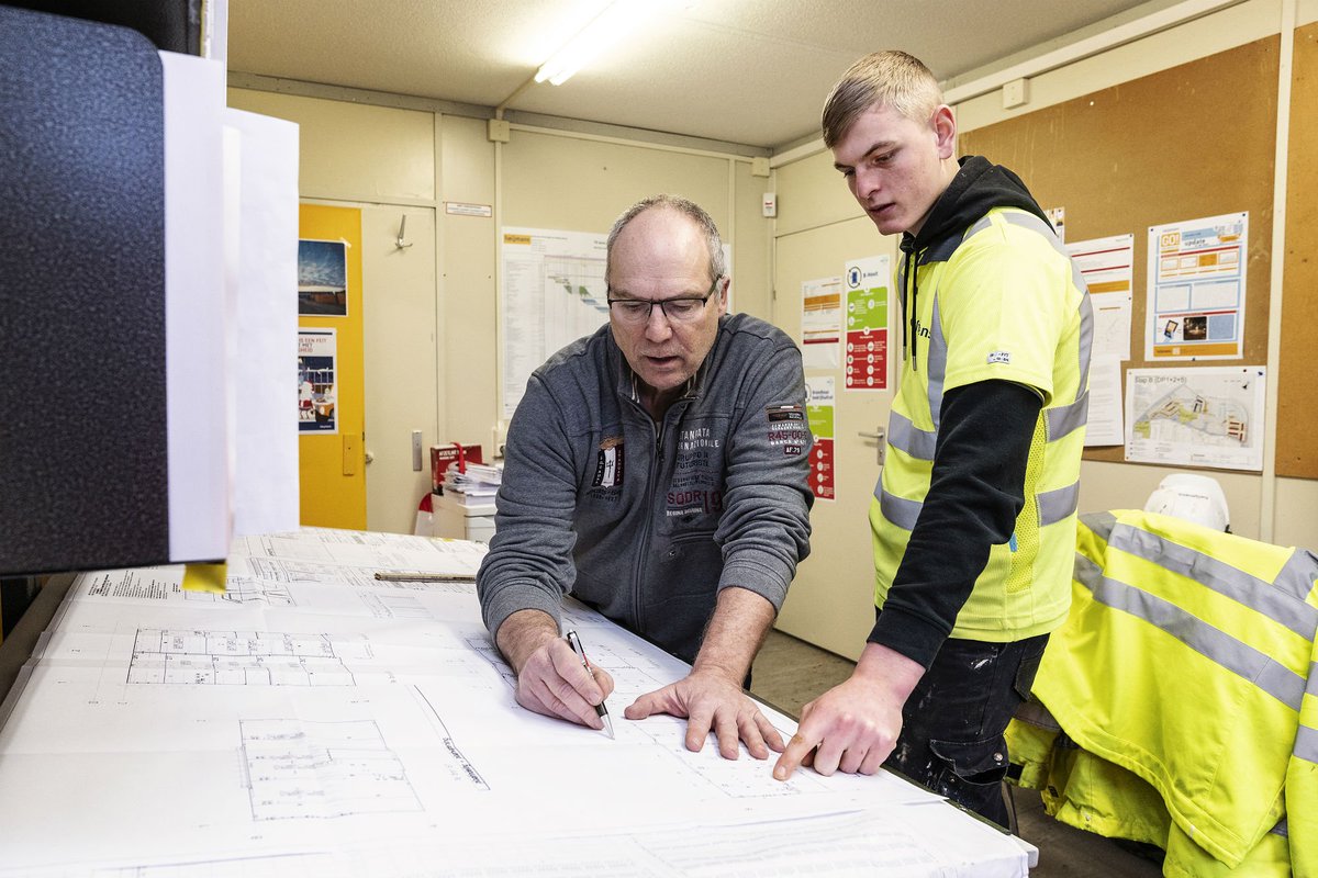 Leerling Stef Kerkhoven (17) met zijn leermeester Rob Peetoom in de keet, technische tekeningen leren lezen. "We maken veel lol. Maar we werken ook hard hoor." Ook #lerenbijHeijmans? Zie bit.ly/Leren_bij_Heij…