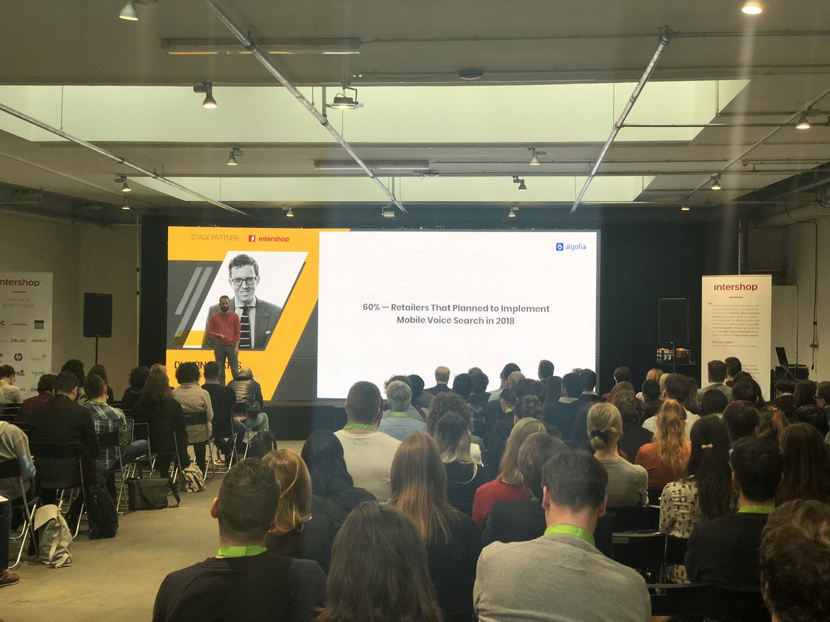christinafeld's tweet photo. „60% of retailers plan to implement #voicesearch“ My colleague @dcoates speaking at #ecomberlin. The room is packed - it’s a hot topic. Come meet us at the @algolia booth D7.2 to talk about how you can be one of the early adopters in Europe, too @ecommerceberlin https://t.co/EpOo6mxYBH