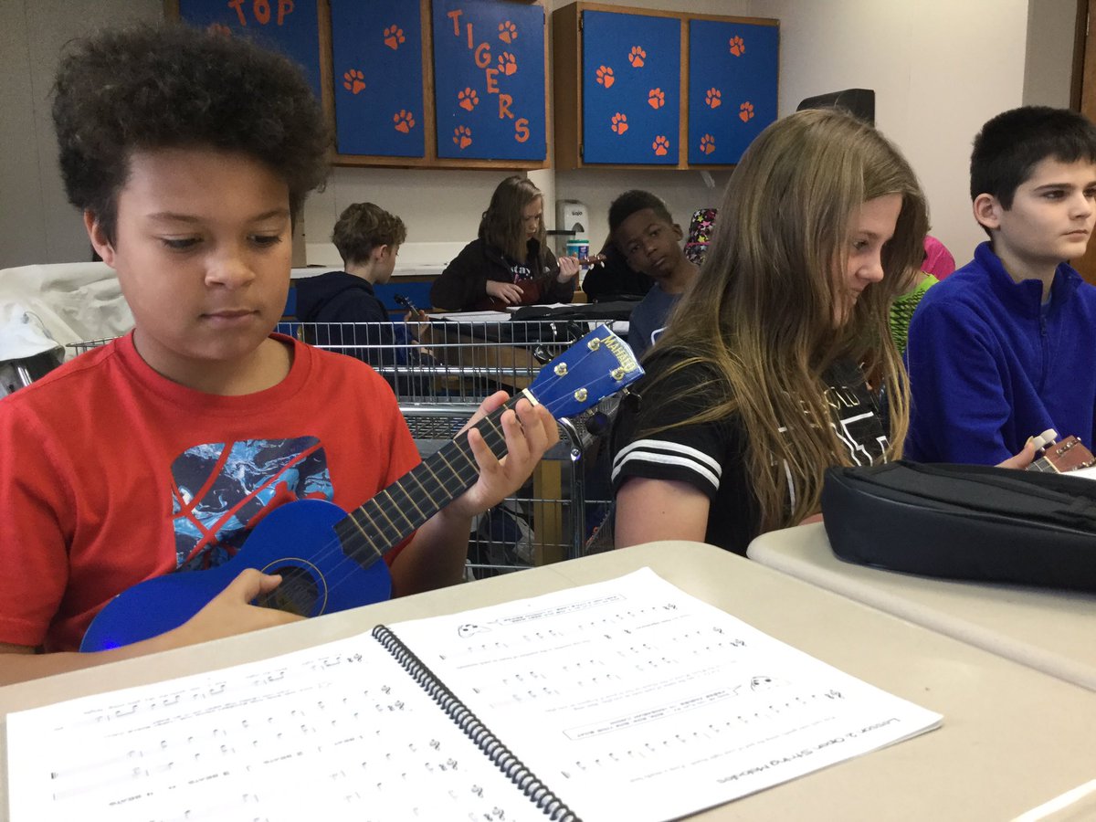 Ss use Ukuleles in the Classroom lesson book to practice open string melodies. #iteachmusic #elmused