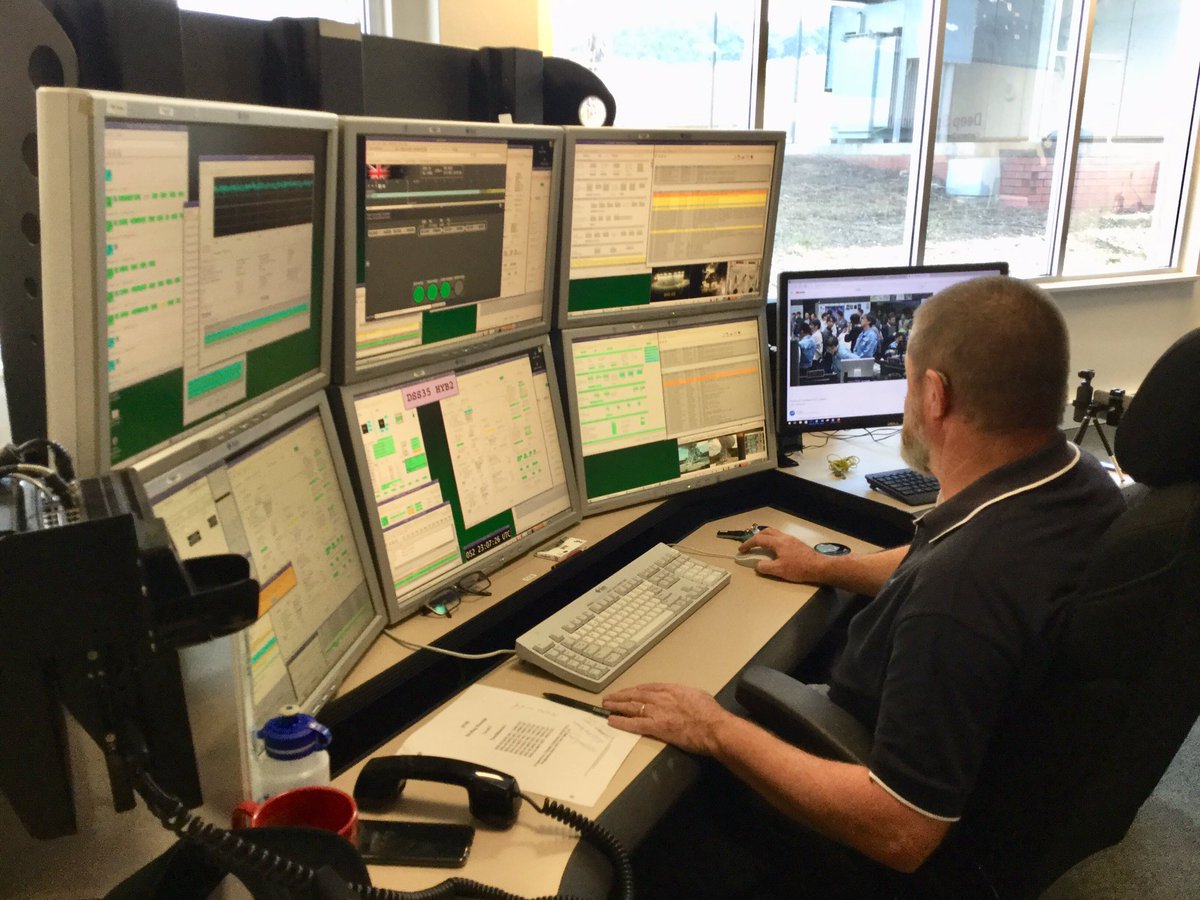 Person operating space communications system with multiple computer screens.