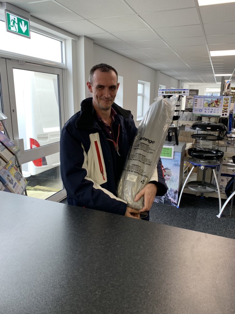 Mr Stafford collecting his porch awning after winning it in the raffle