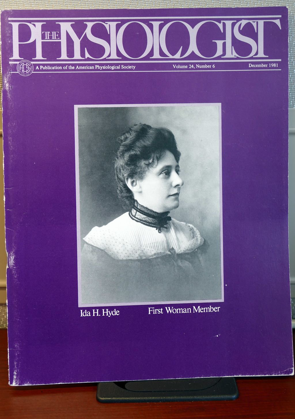 A cover of the December 1981 issue of The Physiologist featuring a image of a women in early 1900s clothing. The image is labeled "Ida H. Hyde, First Woman Member"