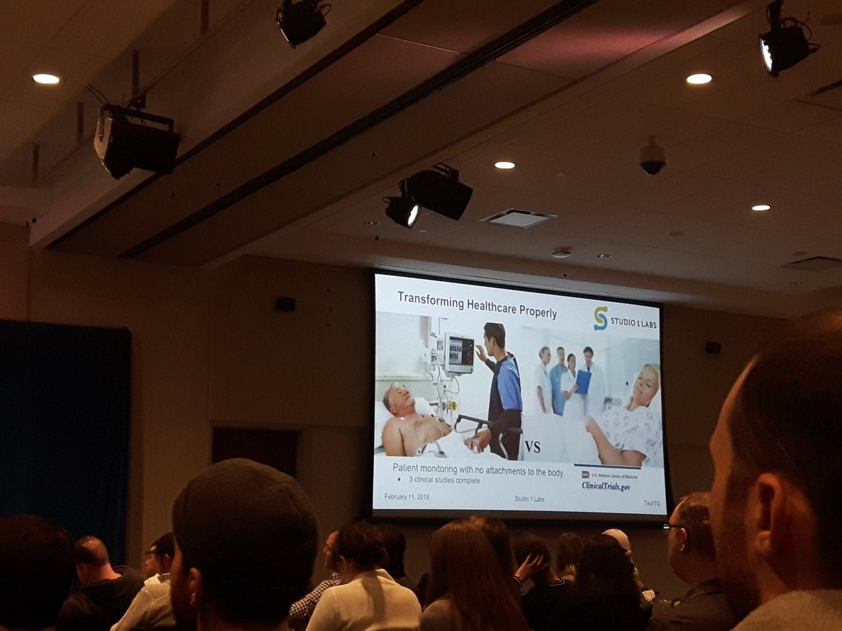 yasminzaimi's tweet photo. First time at #TechTO - love an event that's both entertaining (genuine laughs) and educational. On screen is the intelligent bedsheet by #healthtech startup @Studio1Labs - looks like a normal fabric but has built-in sensors that monitor the #patient's vitals https://t.co/yte1Lv9pLP