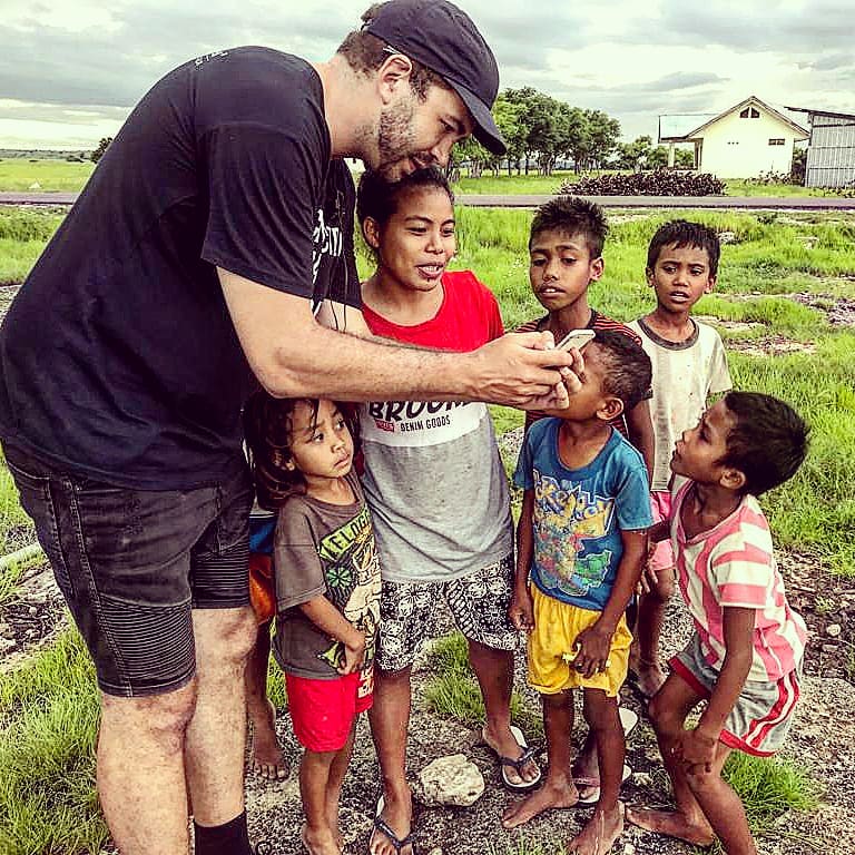 SCC_Innovators's tweet image. SCCei Coordinator Nic's mind lives at both ends of the development spectrum. While in a remote community in Indonesia to check on a small solar system he installed last year, he chatted with kids about potential applications of geo-tagging and drones. Note the #scwaus shirt 👌