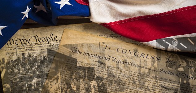 an image of the American flag drapped over the U.S. Constitution