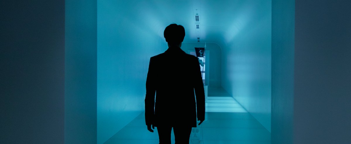 A shot from behind of Hideo Kojima in his studio.