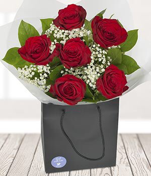 Slightly nervously hands <a href="/Queen_Cordette/">Cordelia Chase</a> these. “Happy Valentine’s Day, Cordy.”