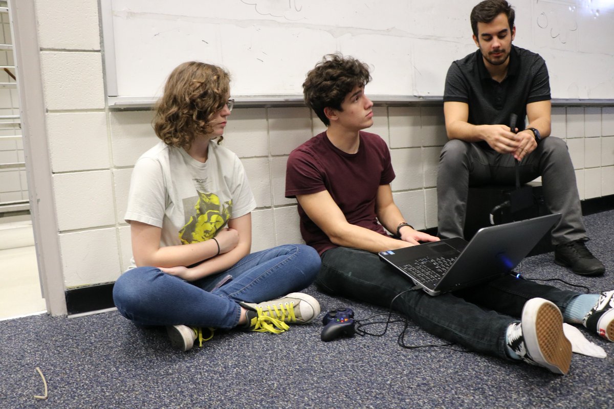 Our programmers Suzanne, Logan, Ronny, and mentor Tristan teaching them on new topics about programming the robot.