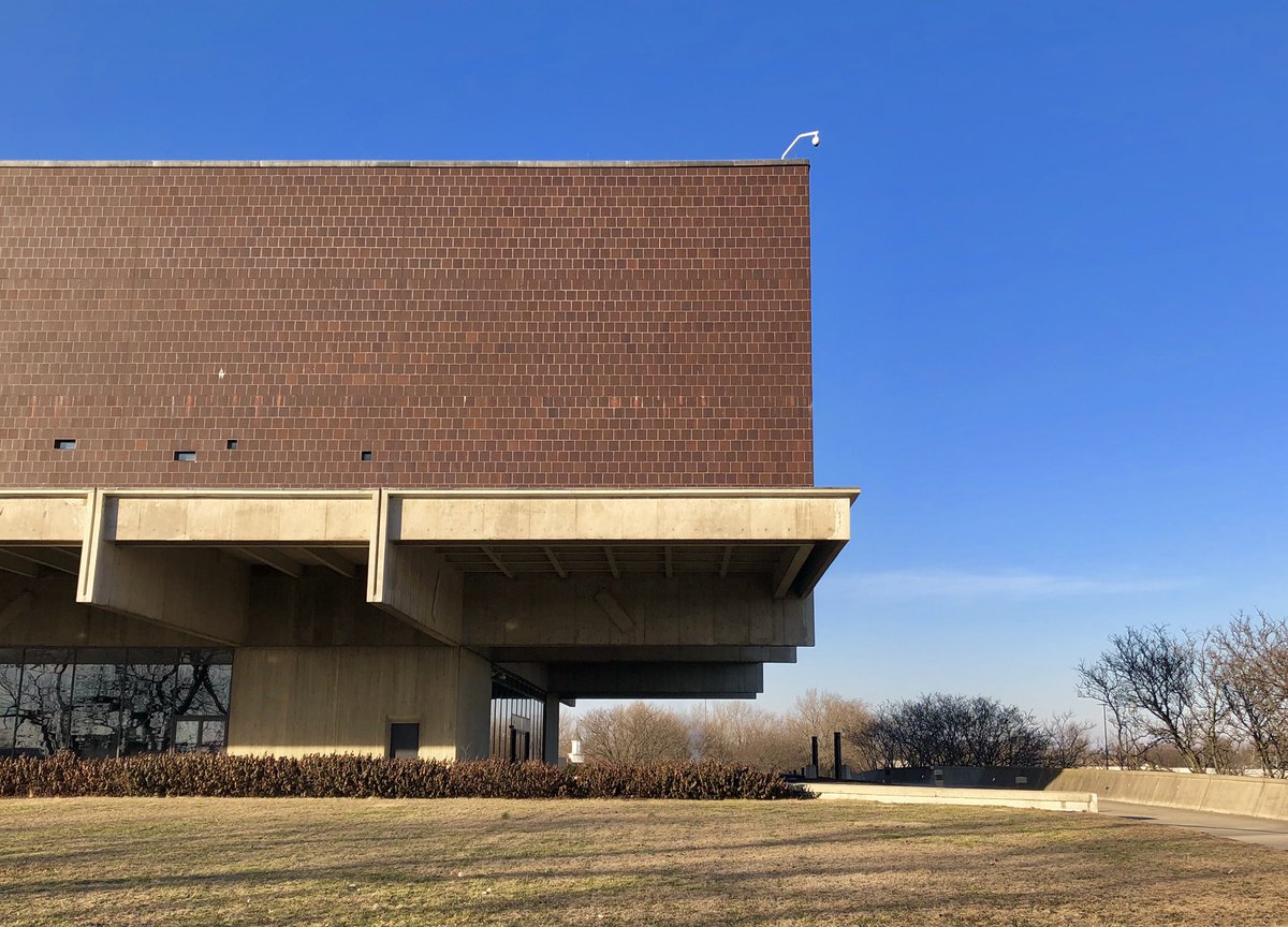 The floating library mass is clad in Ohio grain silo tile, while the mounded site references the Native American earthworks found throughout the state.