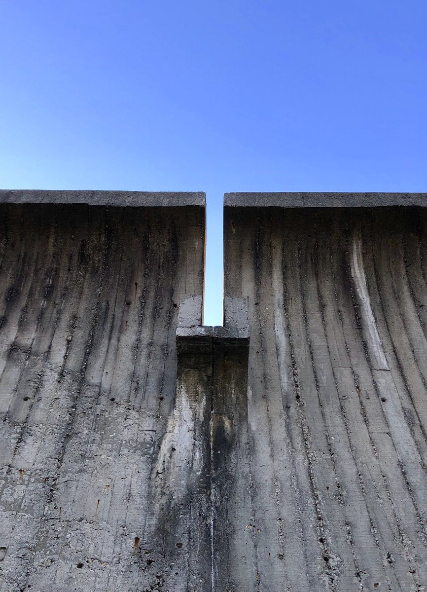 The floating library mass is clad in Ohio grain silo tile, while the mounded site references the Native American earthworks found throughout the state.