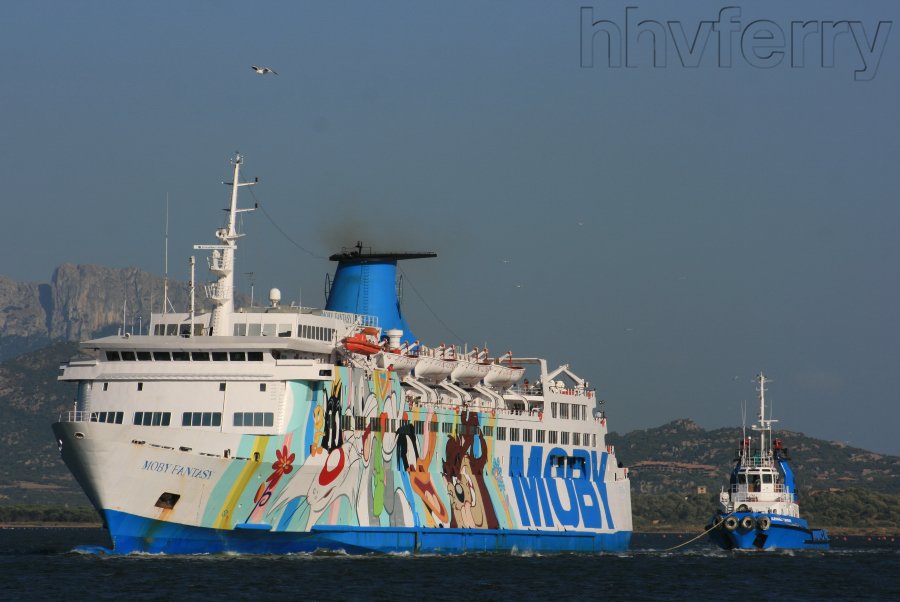 hhvferry's tweet photo. Here's the dear old tub at Olbia and being kept on a very tight lead by one of Moby's tugs. The Moby Fantasy was finally scrapped in 2013. #mobyfantasy @MobyClub https://t.co/zRq1FGZJ7G